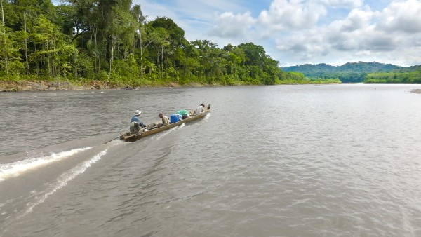 Three men in a boat on a river