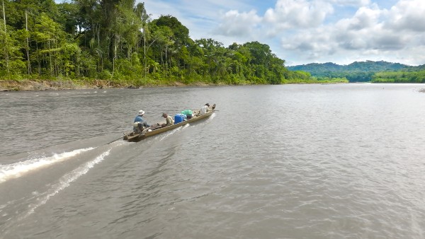 Three men in a boat on a river