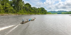 Three men in a boat on a river
