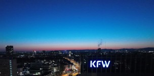 KfW logo on the main house after dark