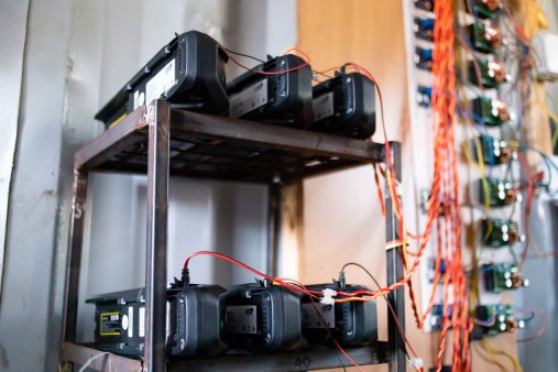 Charging e-bike batteries on a shelf