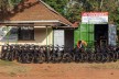 There are many e-bikes in front of a house and container