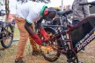 A man welding on the rear wheel of an e-bike.