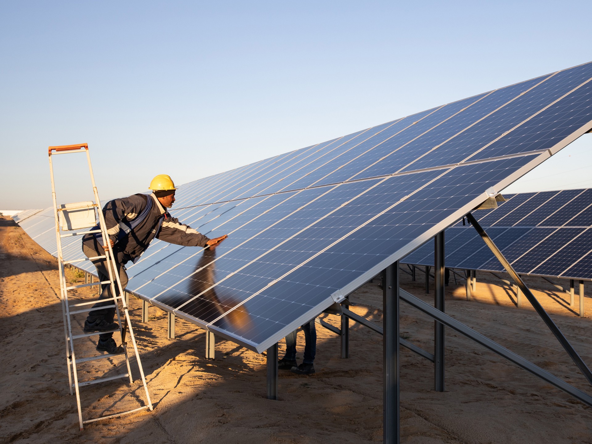Worker inspects a large solar installation 
