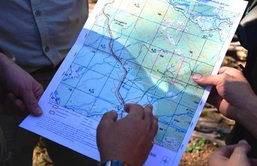 Rangers hold a map of the protected area in the Annamite Range in their hands.