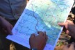 Rangers hold a map of the protected area in the Annamite Range in their hands.
