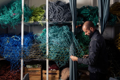 Benjamin Wenke from Bracenet in front of old fishing nets