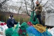 Two men are standing on old fishing nets that are just arriving at Bracenet