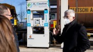 One of the founders of Buses4Future in front of a hydrogen gas pump.