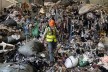 man standing in garbage pile
