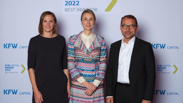 award winner Littek and 2 other persons in front of the press wall