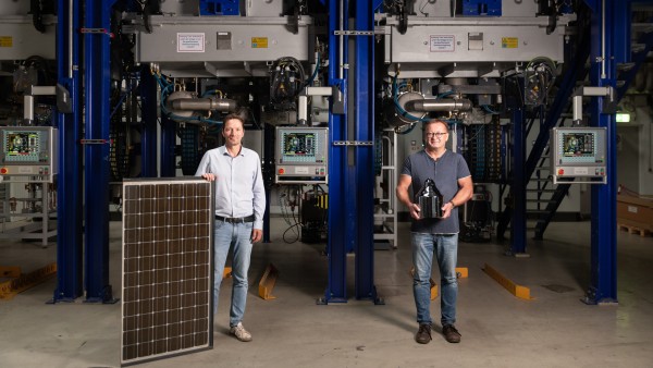 Wolfram Palitzsch and Dr. Ingo Röver (from left), founders of LuxChemtech, pose with a silicon block and a solar panel