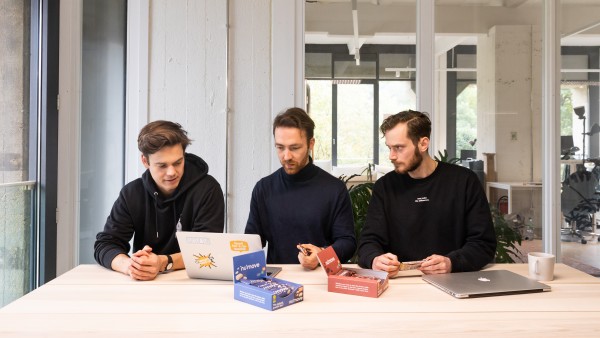 the three founders are sitting on their laptops