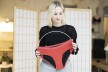 Woman holding red periode underwear in her hands