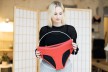 Woman holding red periode underwear in her hands