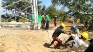 Builders in Myanmar, setting up a mobile phone mast