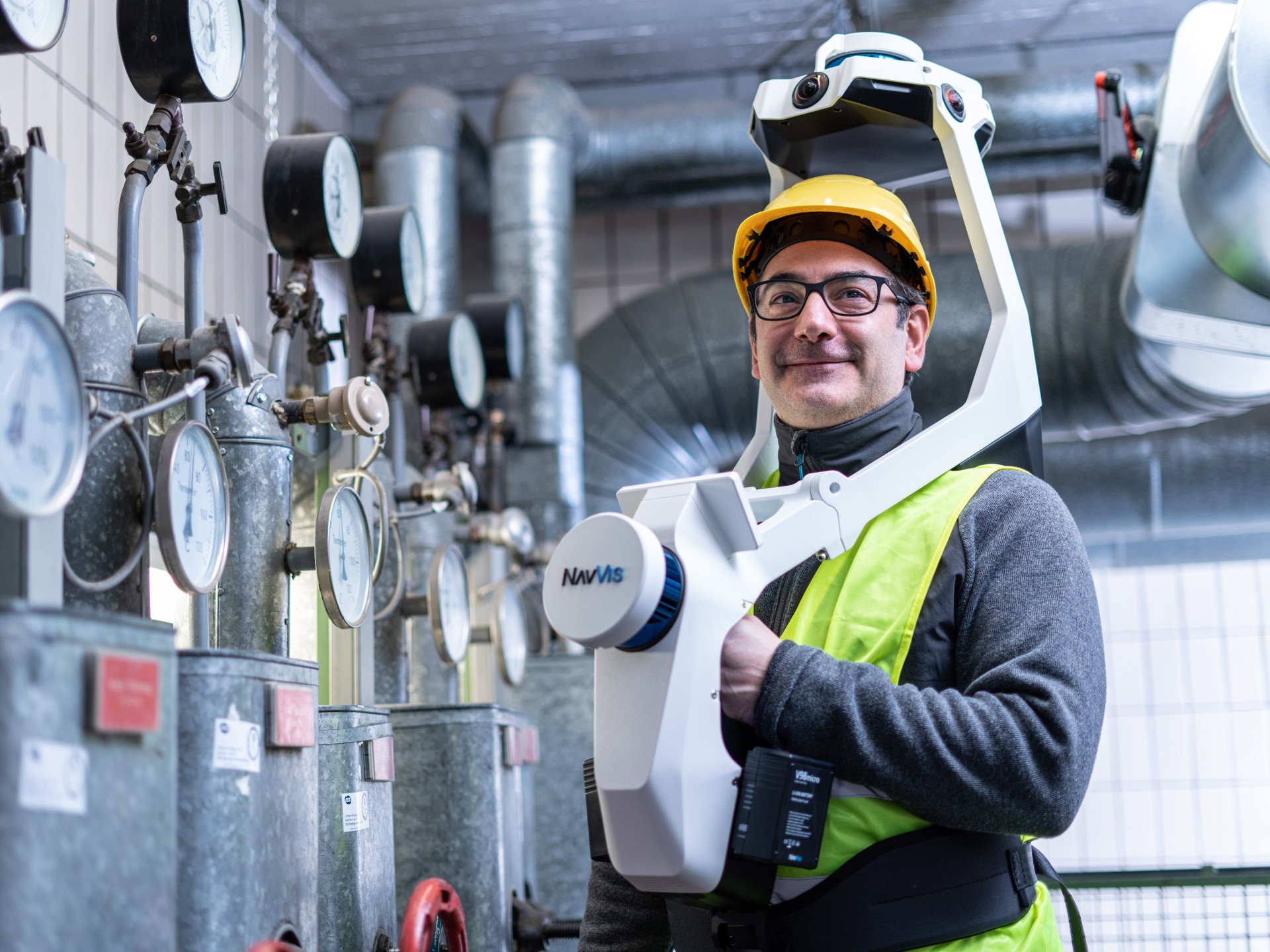 Man with mobile mapping system in engine room.