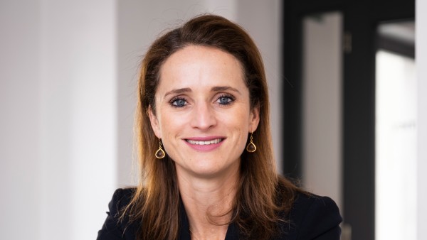 Verena Pausder sits in front of her notebook with a smile