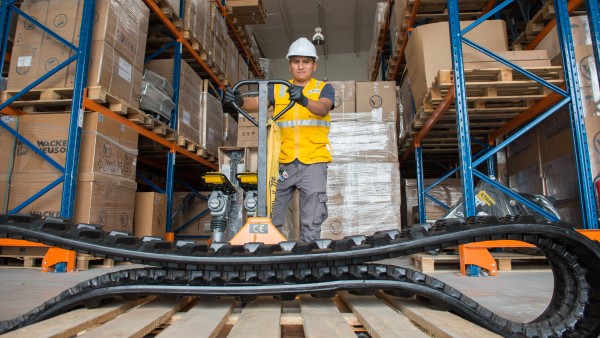 A worker unloads construction equipment