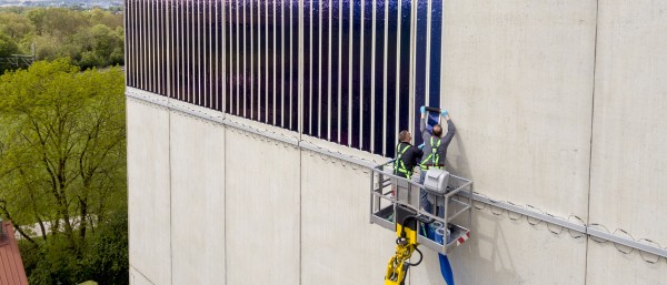 Two man attaching solarfilms onto a wall