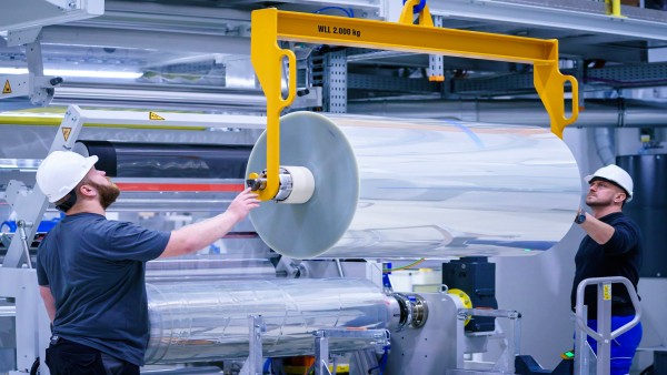 Two employees installing durning coil loading