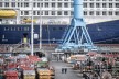 A crane is in front of a cruise ship on the shipyard site