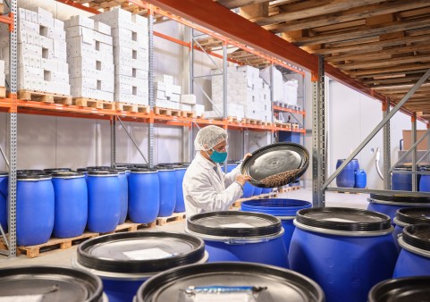 Site manager Tobias Franke in the warehouse with coffee barrels