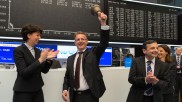 va-Q-tec CEO Kuhn with a bell in his hand as he launches trading on the floor of the Frankfurt stock exchange