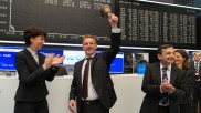 va-Q-tec CEO Kuhn with a bell in his hand as he launches trading on the floor of the Frankfurt stock exchange